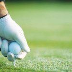 Close-up of a low spin golf ball on a tee, ready for a drive, highlighting improved accuracy and distance