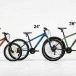 Three different sized mountain bikes (20, 24, and 26 inches) lined up for size comparison.