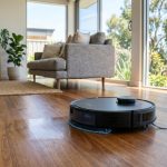 Affordable robot vacuum and mop cleaning a modern living room floor.