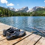 Budget water shoes resting on a wooden dock by a Colorado mountain lake.